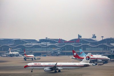 Passengers checking in at a modern airport counter, illustrating the practical steps of travel preparation